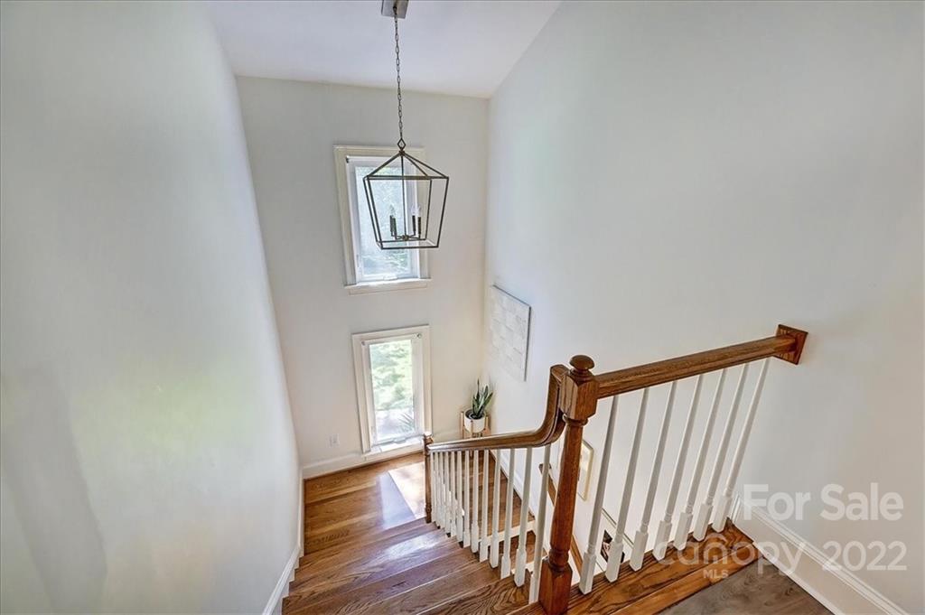 18600 Hammock Lane Davidson, NC 28036 - Photo 28 of 48 a view of a hallway with wooden floor and staircase