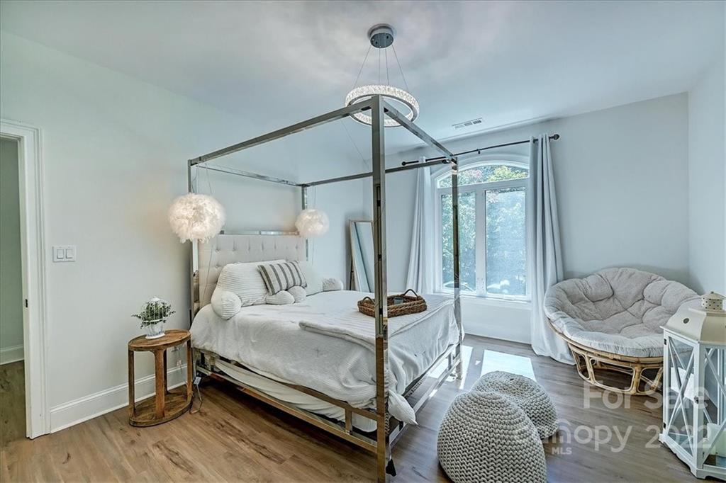 18600 Hammock Lane Davidson, NC 28036 - Photo 29 of 48 a bedroom with a bed and a chandelier