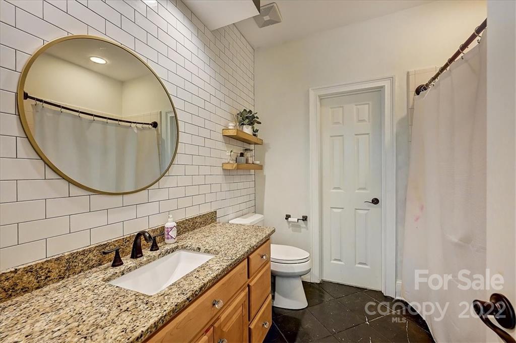 18600 Hammock Lane Davidson, NC 28036 - Photo 30 of 48 a bathroom with a granite countertop toilet sink and mirror