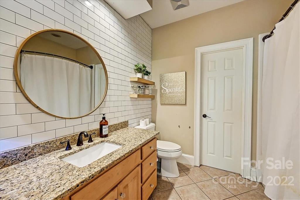 18600 Hammock Lane Davidson, NC 28036 - Photo 32 of 48 a bathroom with a granite countertop sink and a mirror