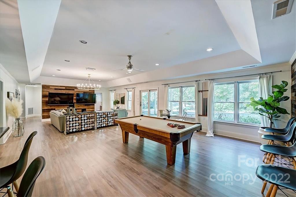 18600 Hammock Lane Davidson, NC 28036 - Photo 33 of 48 a living room with furniture floor to ceiling window and wooden floor