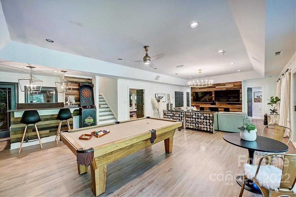 18600 Hammock Lane Davidson, NC 28036 - Photo 37 of 48 a living room with furniture flat screen tv and a wooden floor