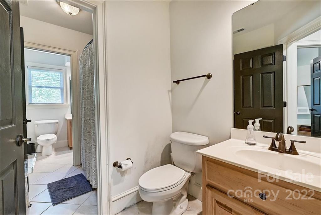 18600 Hammock Lane Davidson, NC 28036 - Photo 41 of 48 a spacious bathroom with a granite countertop toilet sink and a mirror