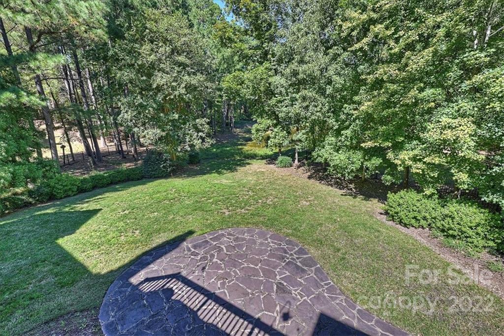 18600 Hammock Lane Davidson, NC 28036 - Photo 47 of 48 a view of a yard with plants and a bench