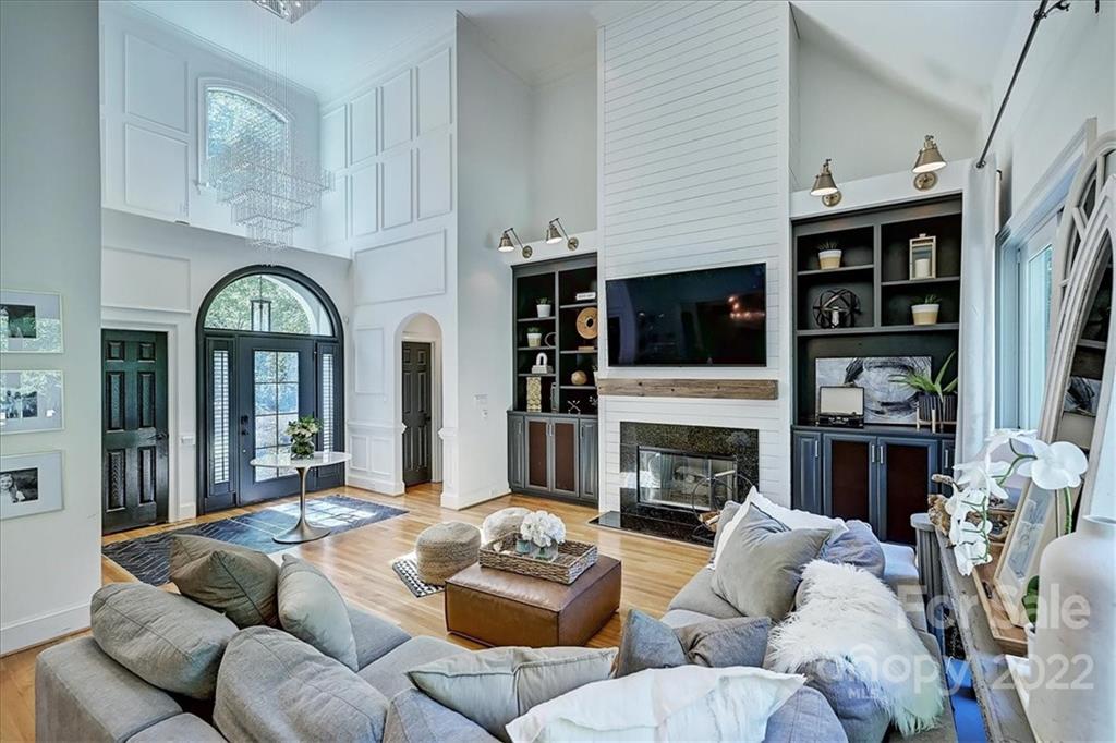 18600 Hammock Lane Davidson, NC 28036 - Photo 5 of 48 a living room with furniture a fireplace and a flat screen tv