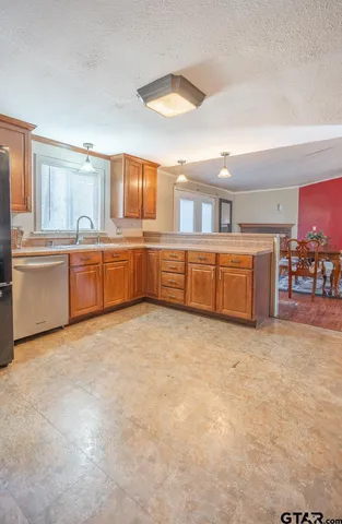 a kitchen with a sink refrigerator and cabinets