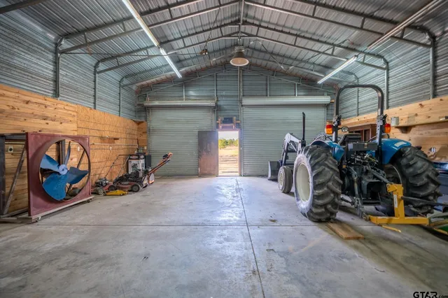 a living room with furniture a ceiling fan a rug and a window