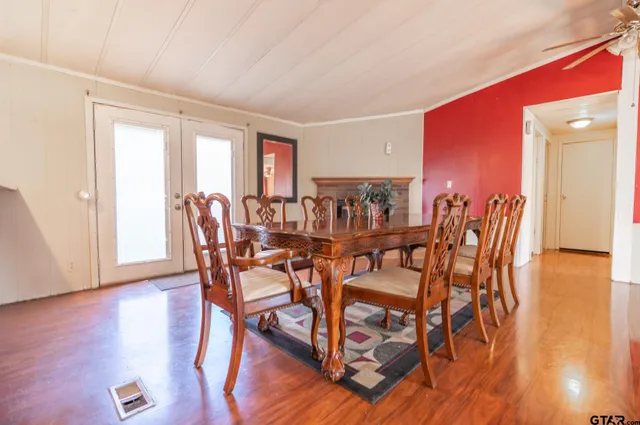 a dining room with furniture and wooden floor