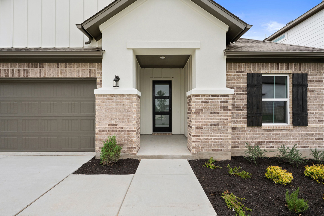 16201 Smithers Road Manor, TX 78653 - Photo 4 of 40 a front view of a house with potted plants