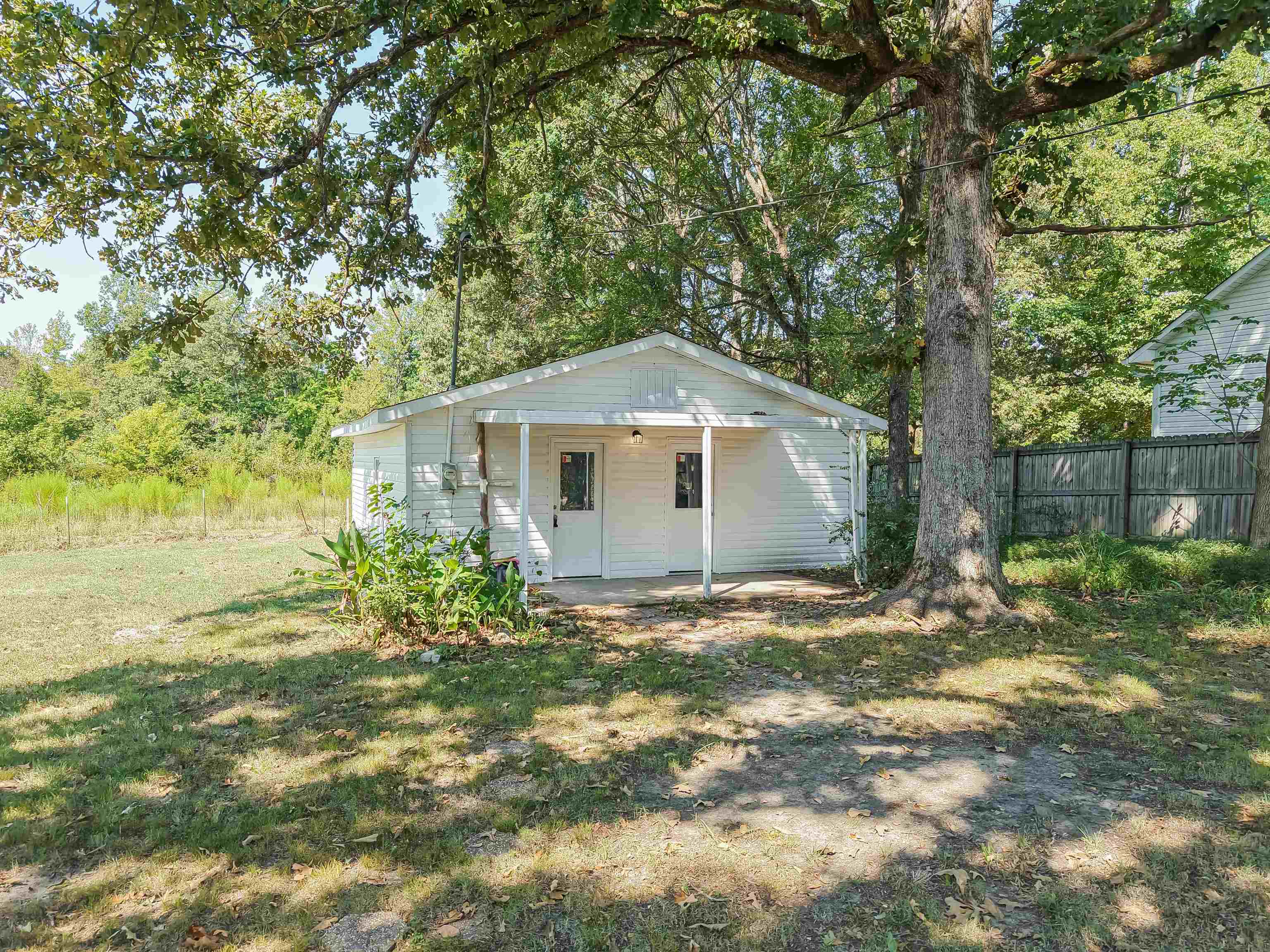 7437 Highway 45 Ramer, TN 38367 - Photo 29 of 36 White siding exterior with a covered porch and mature trees