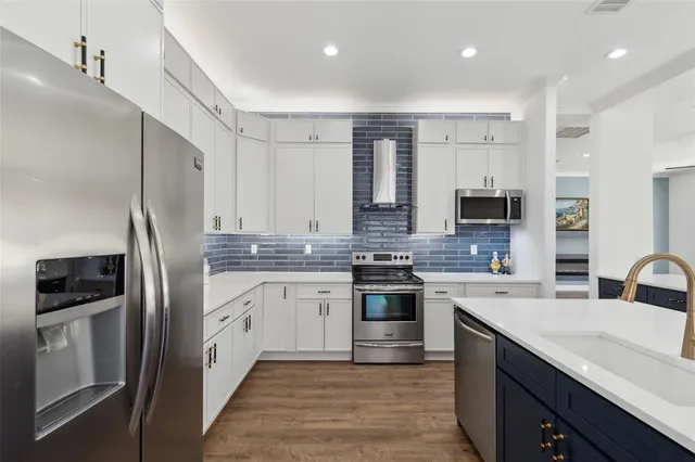 a kitchen with a sink stove and refrigerator
