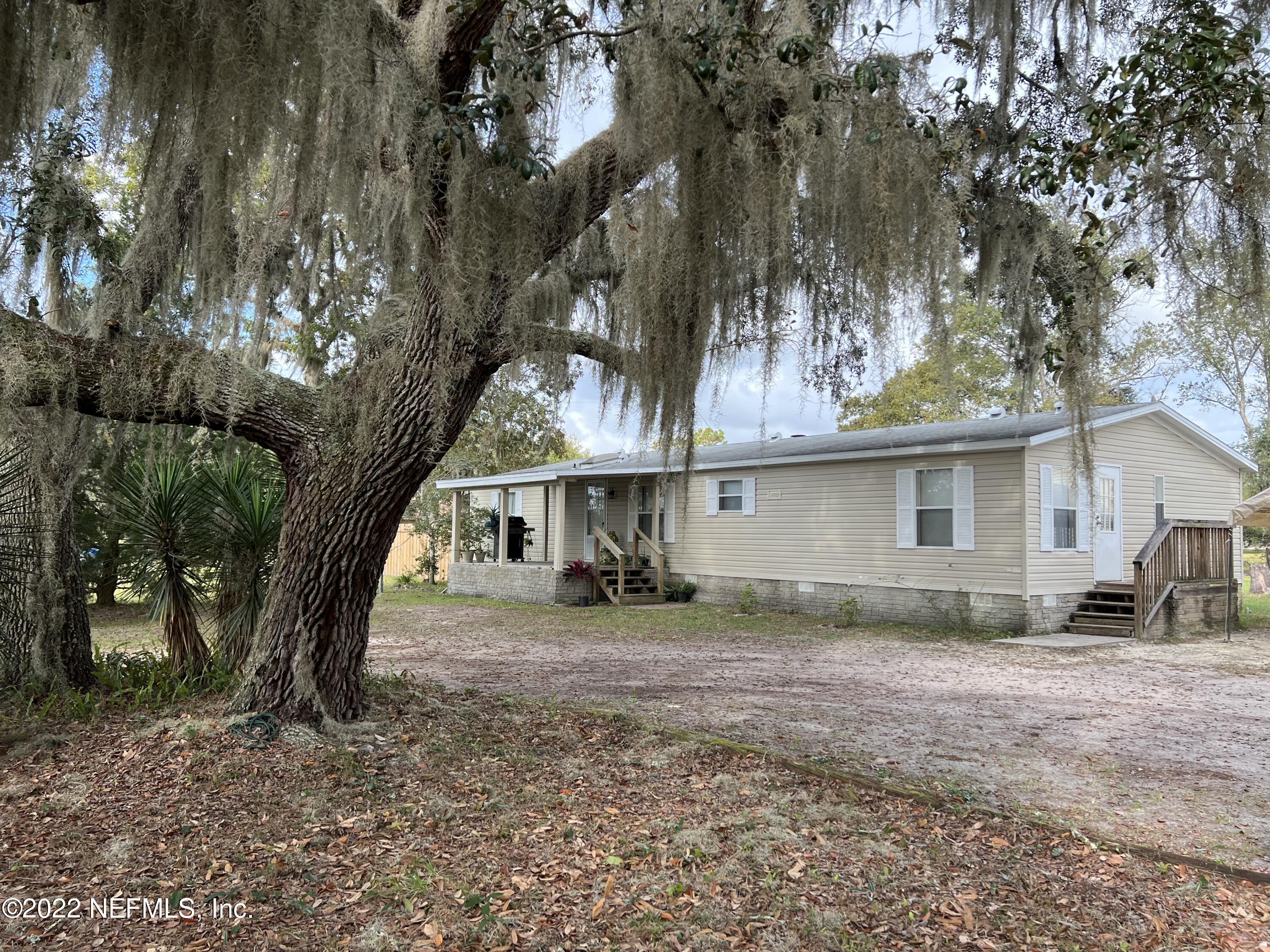 a view of a house with a tree in a yard
