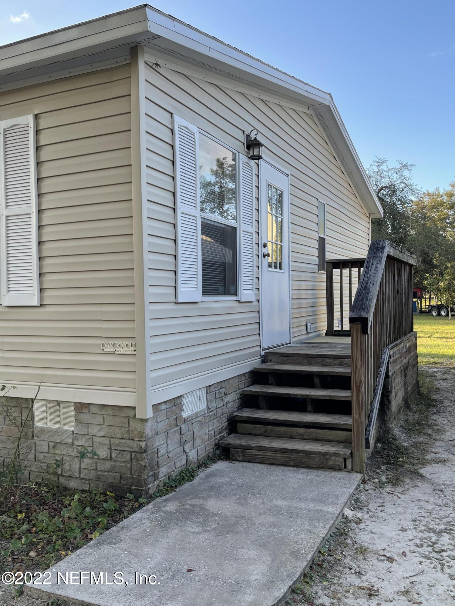 116 Comer Road Palatka, FL 32177 - Photo 30 of 51 a view of a house with backyard and wooden stairs