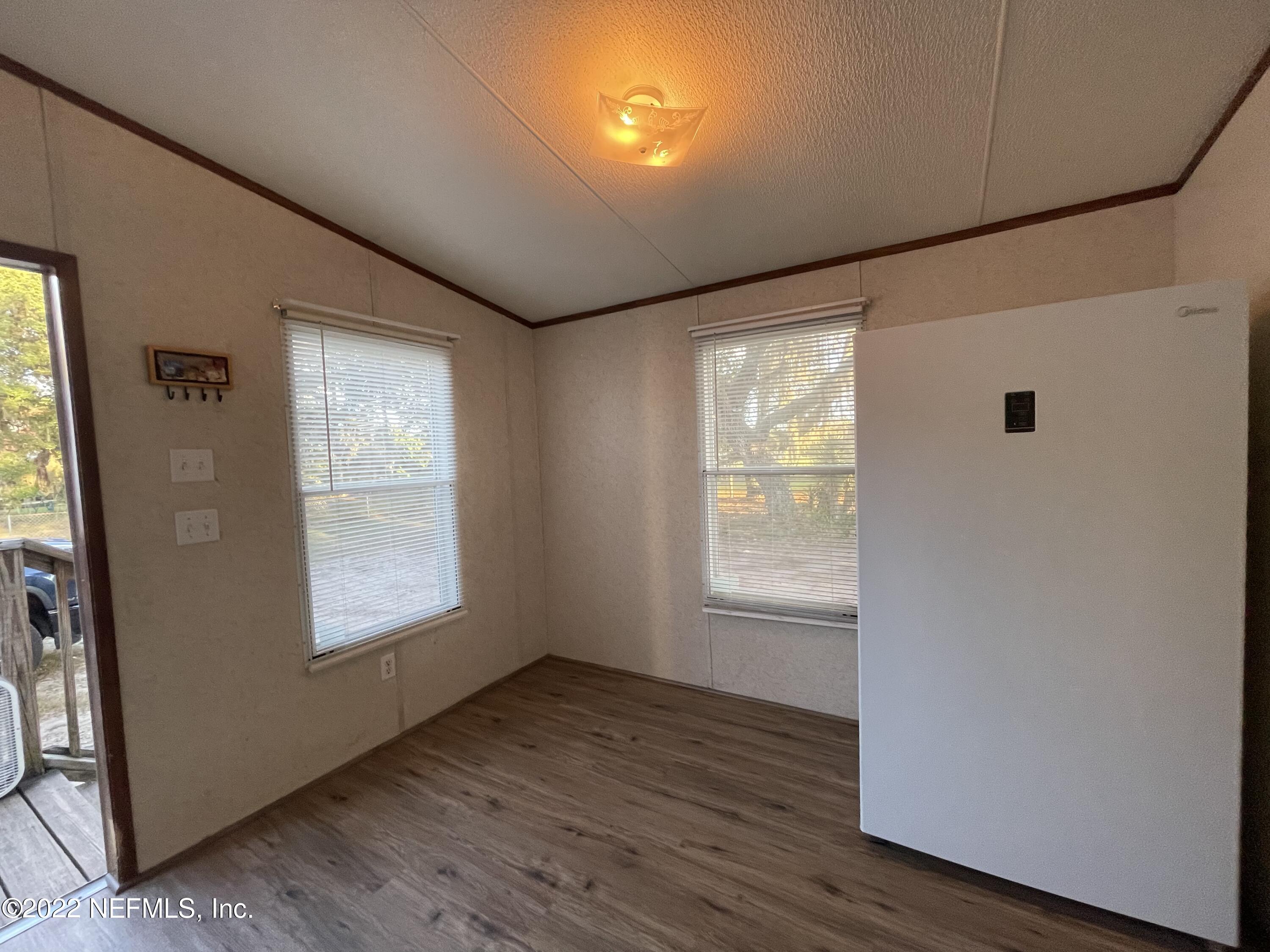 116 Comer Road Palatka, FL 32177 - Photo 31 of 51 an empty room with wooden floor and windows