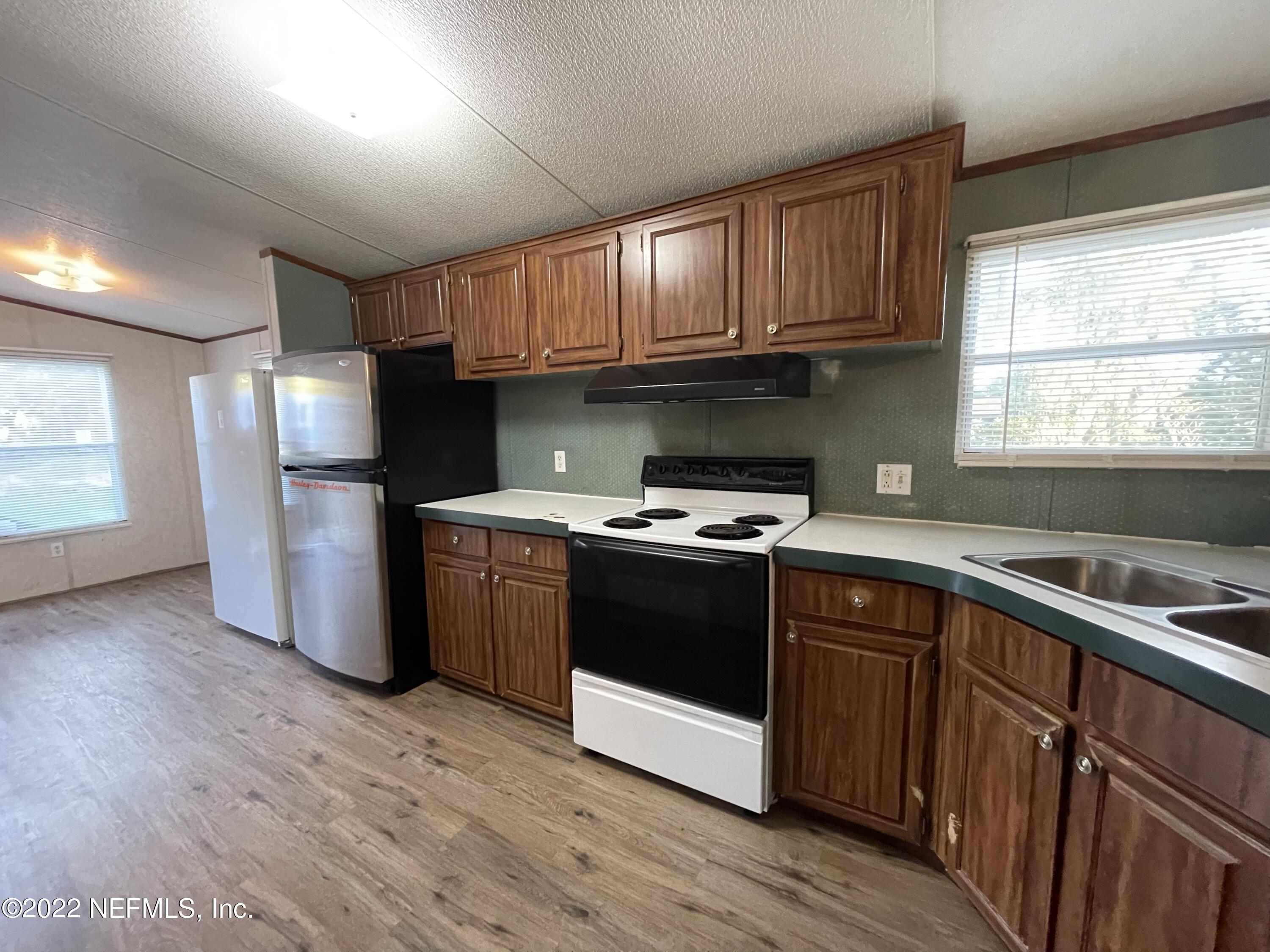 116 Comer Road Palatka, FL 32177 - Photo 32 of 51 a kitchen with stainless steel appliances granite countertop a refrigerator a sink dishwasher a stove and a refrigerator