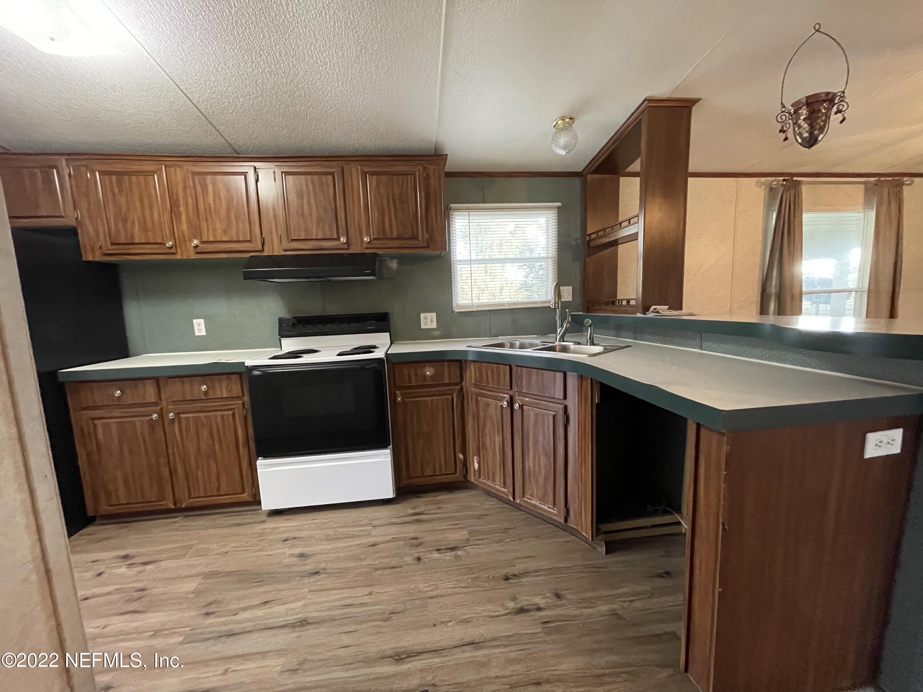 116 Comer Road Palatka, FL 32177 - Photo 33 of 51 a kitchen with stainless steel appliances granite countertop a stove a sink dishwasher and a refrigerator