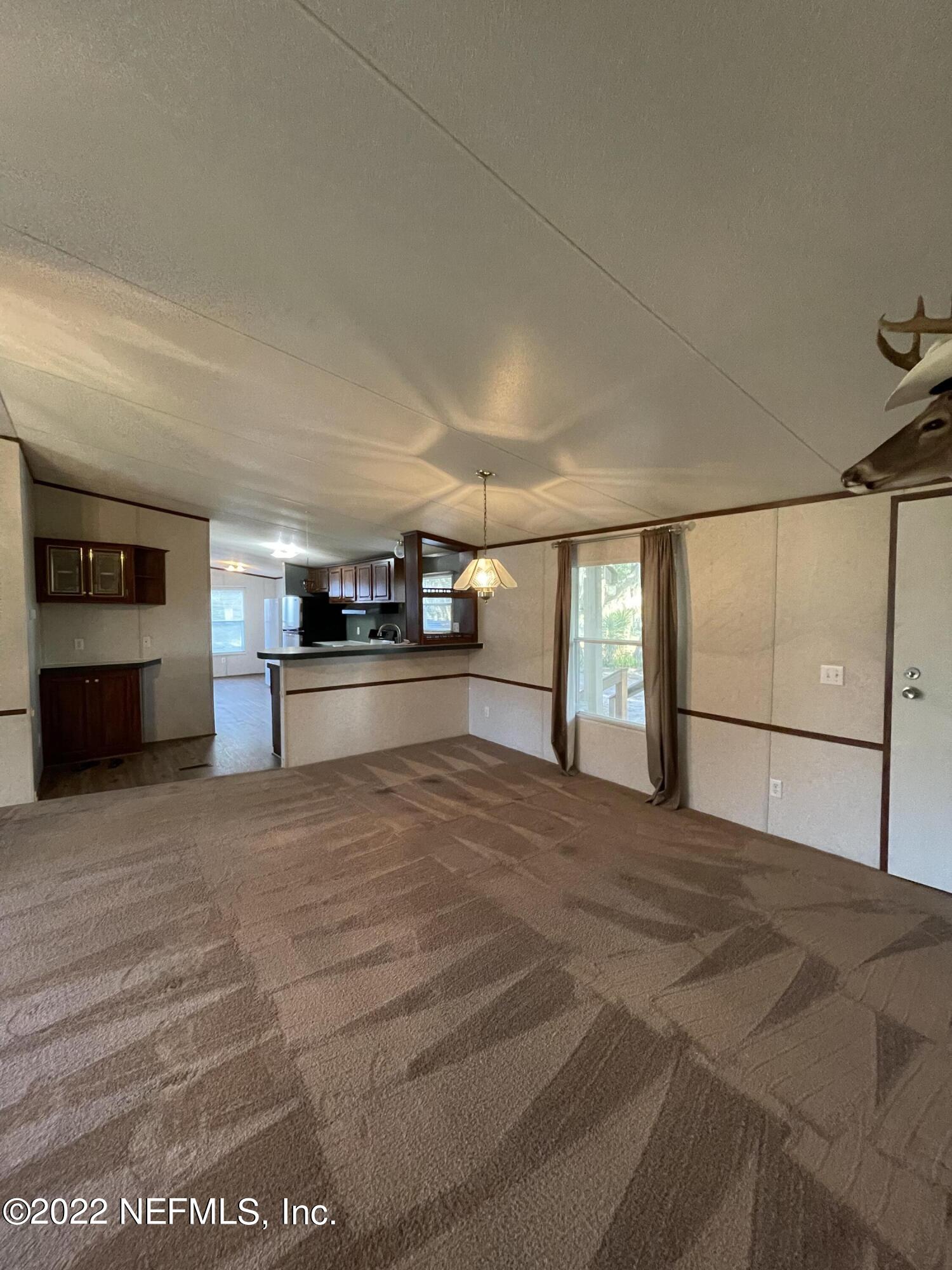 116 Comer Road Palatka, FL 32177 - Photo 34 of 51 a large room with a bed and cabinets