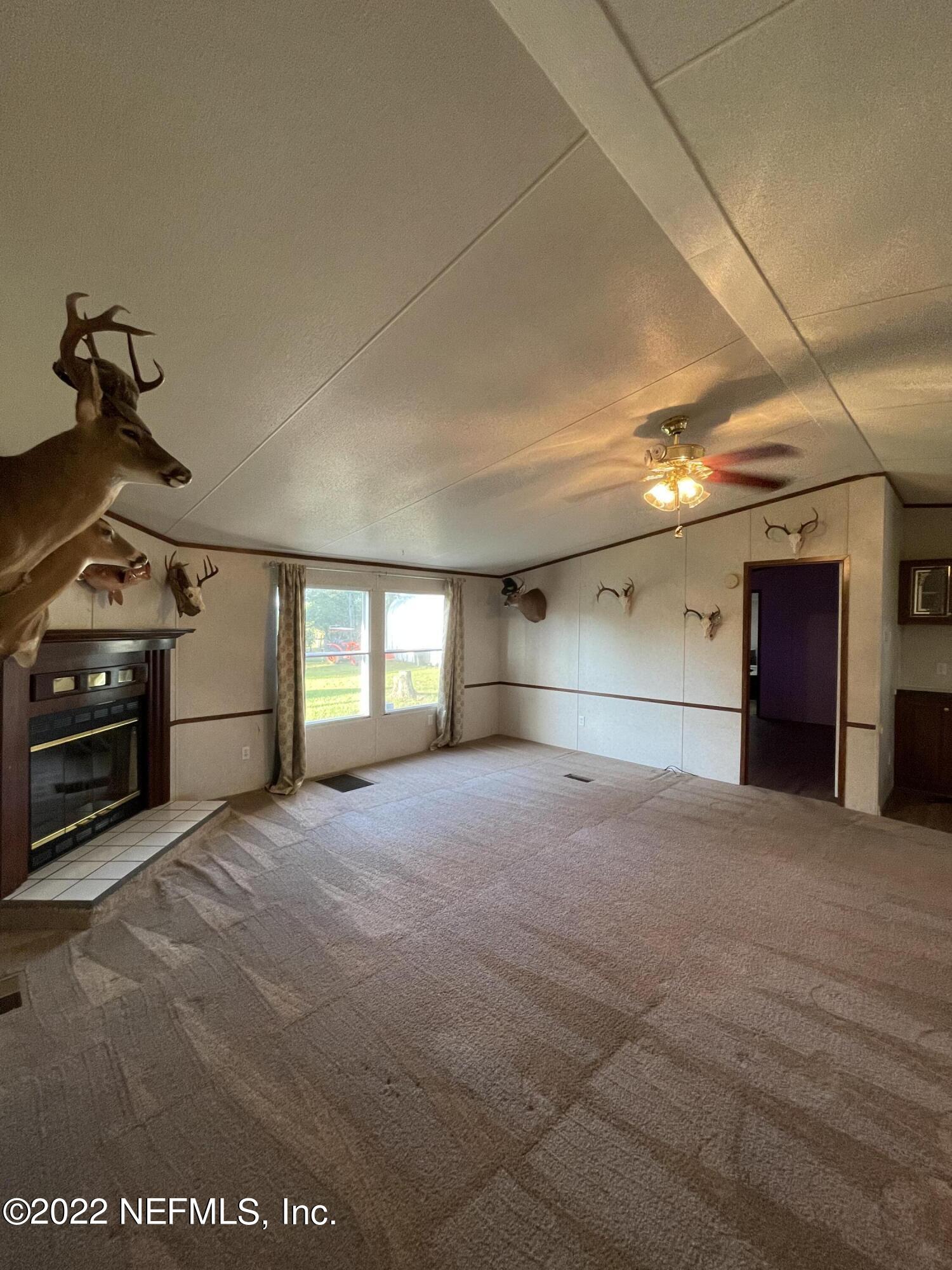 116 Comer Road Palatka, FL 32177 - Photo 35 of 51 a view of a livingroom with a stove and a window