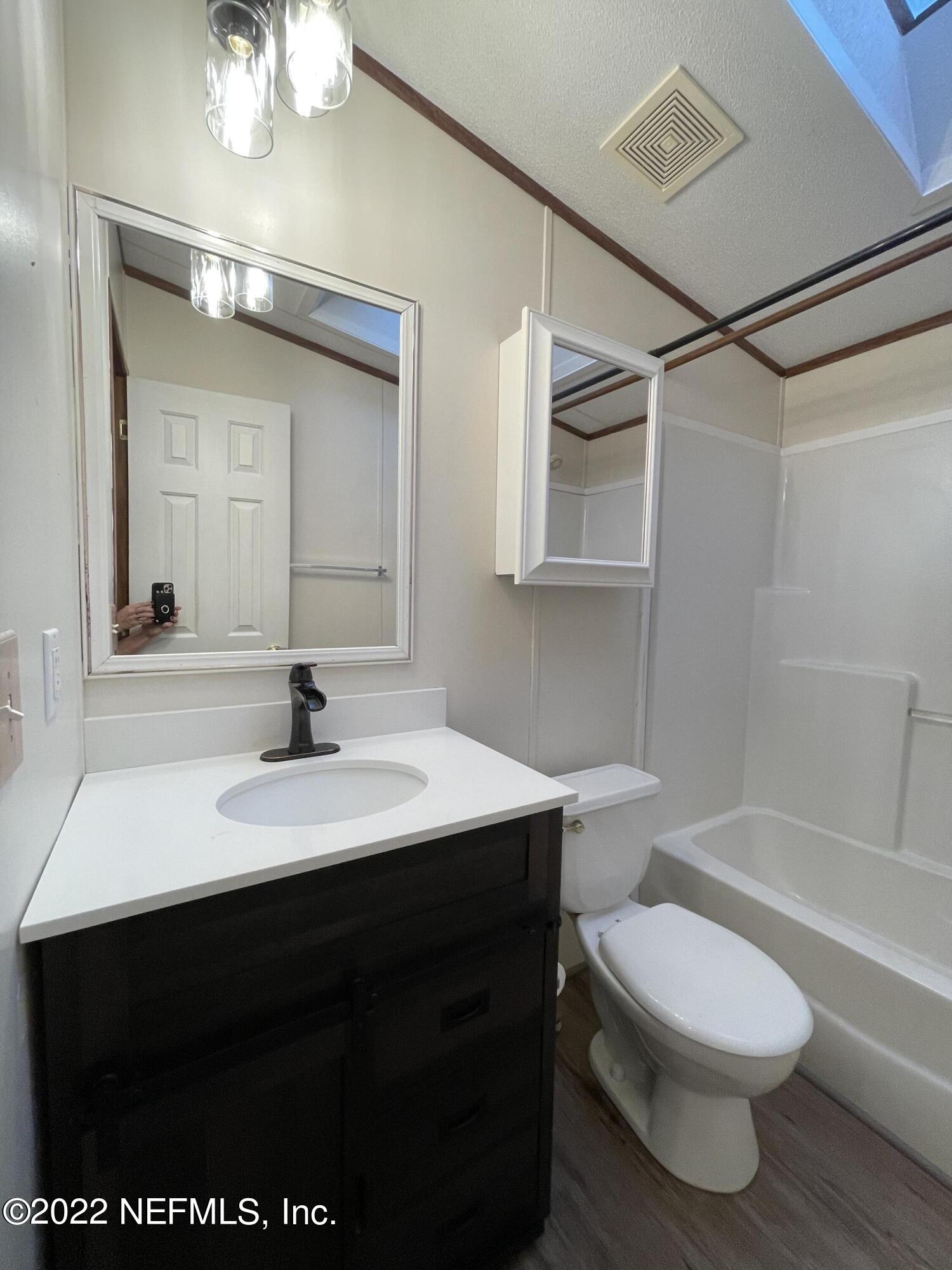 116 Comer Road Palatka, FL 32177 - Photo 39 of 51 a bathroom with a sink a toilet and a mirror