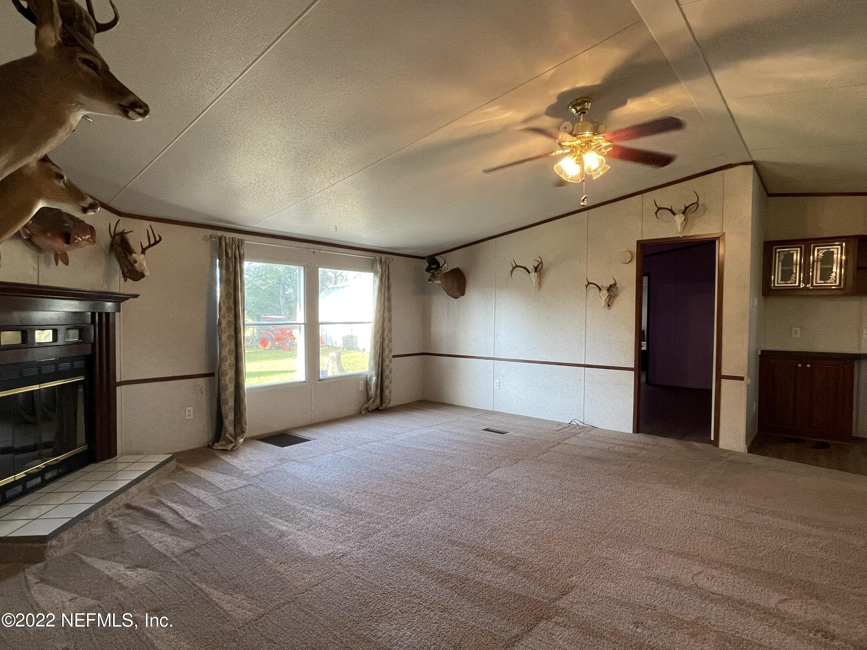 116 Comer Road Palatka, FL 32177 - Photo 40 of 51 a view of empty room with window and chandelier