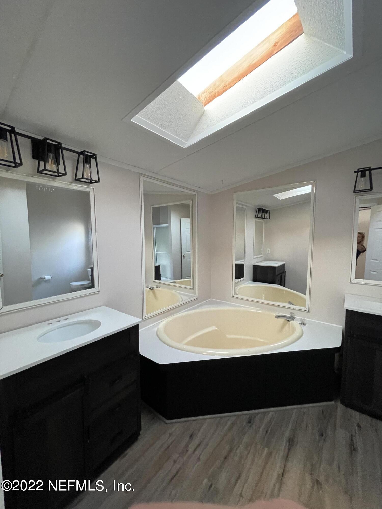 116 Comer Road Palatka, FL 32177 - Photo 41 of 51 a room with a large bed table and mirror