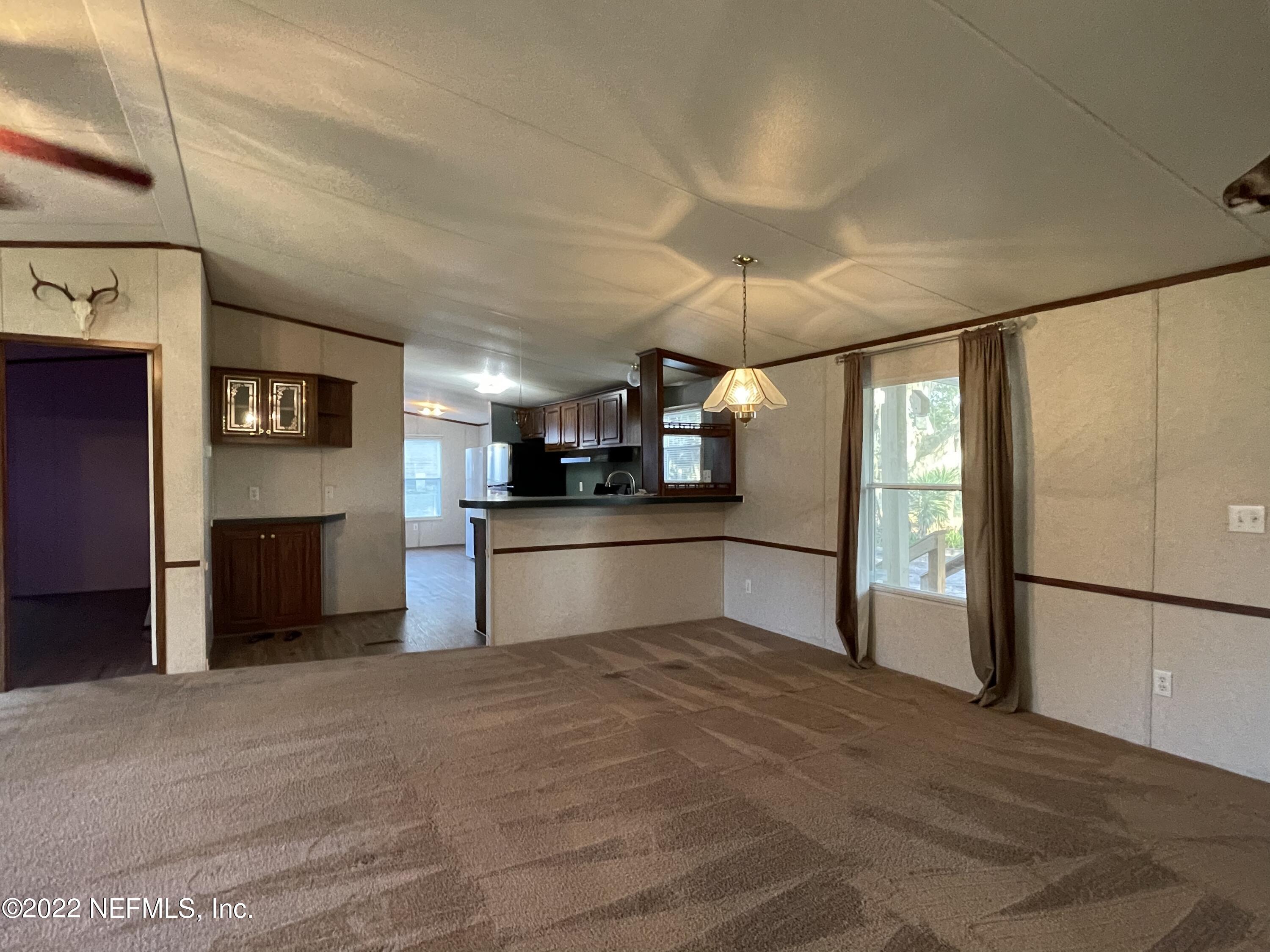 116 Comer Road Palatka, FL 32177 - Photo 43 of 51 a kitchen with stainless steel appliances kitchen island granite countertop a refrigerator and a sink