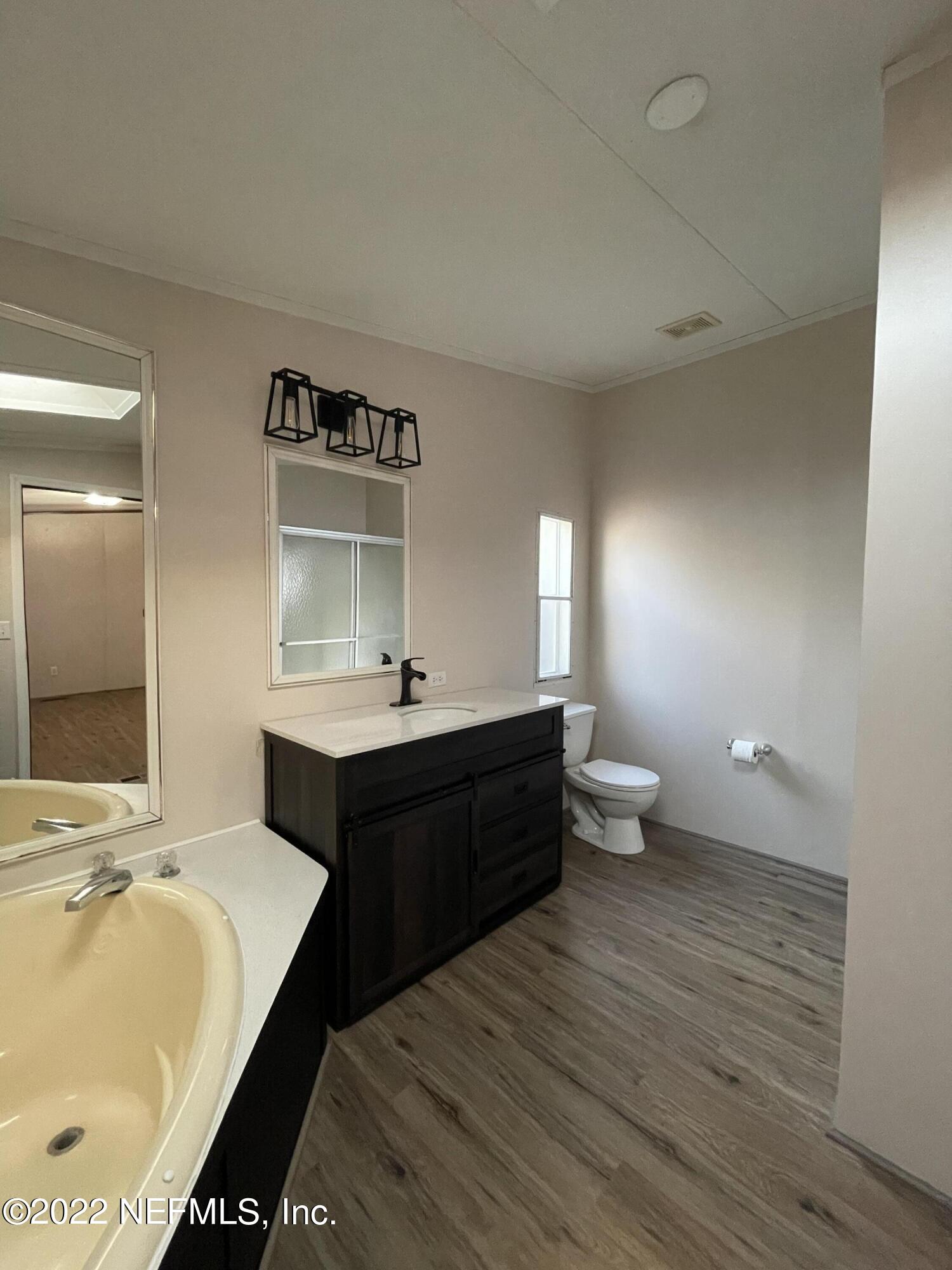 116 Comer Road Palatka, FL 32177 - Photo 45 of 51 a spacious bathroom with a double vanity sink and a mirror