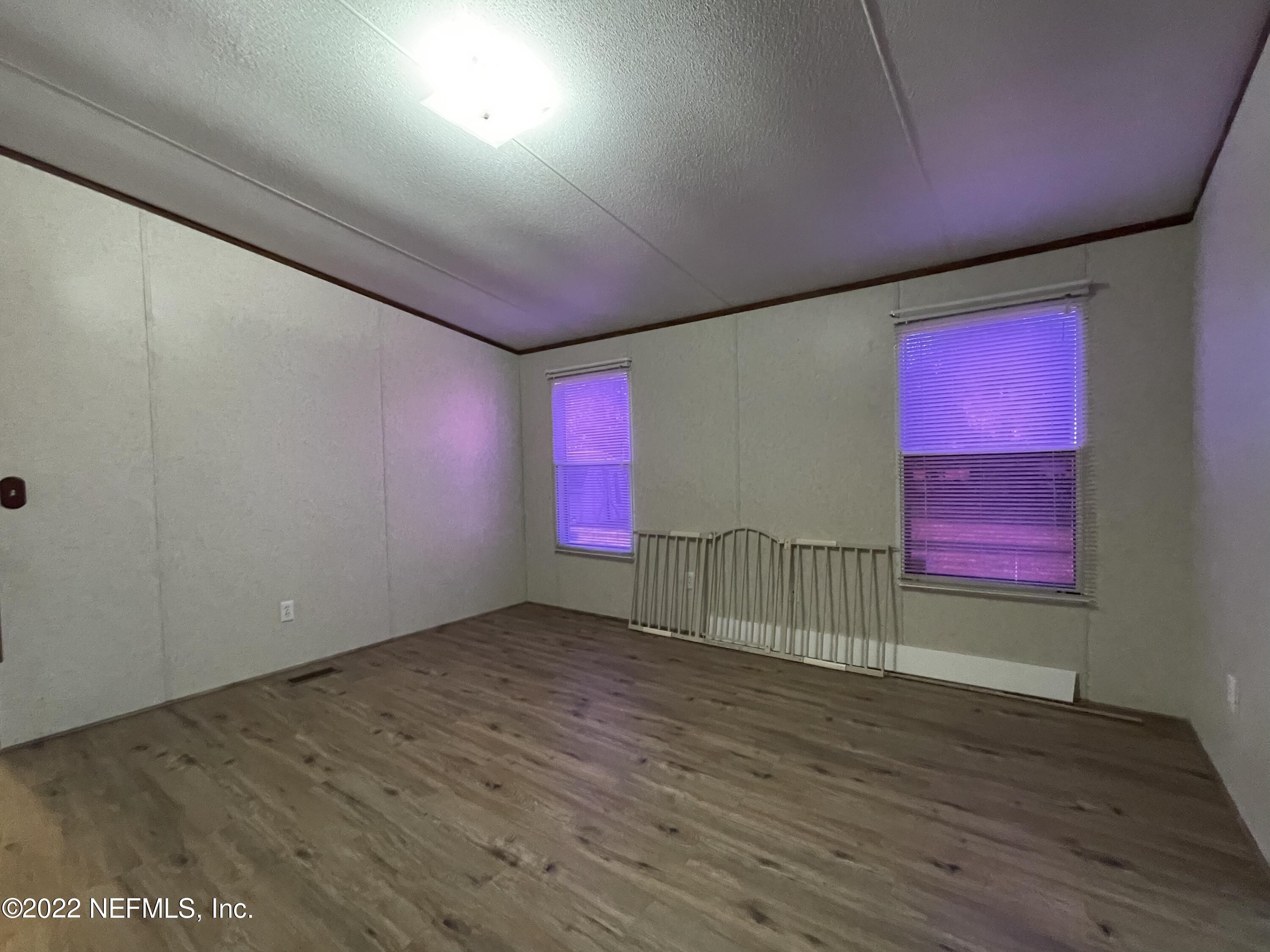 116 Comer Road Palatka, FL 32177 - Photo 46 of 51 an empty room with wooden floor and windows