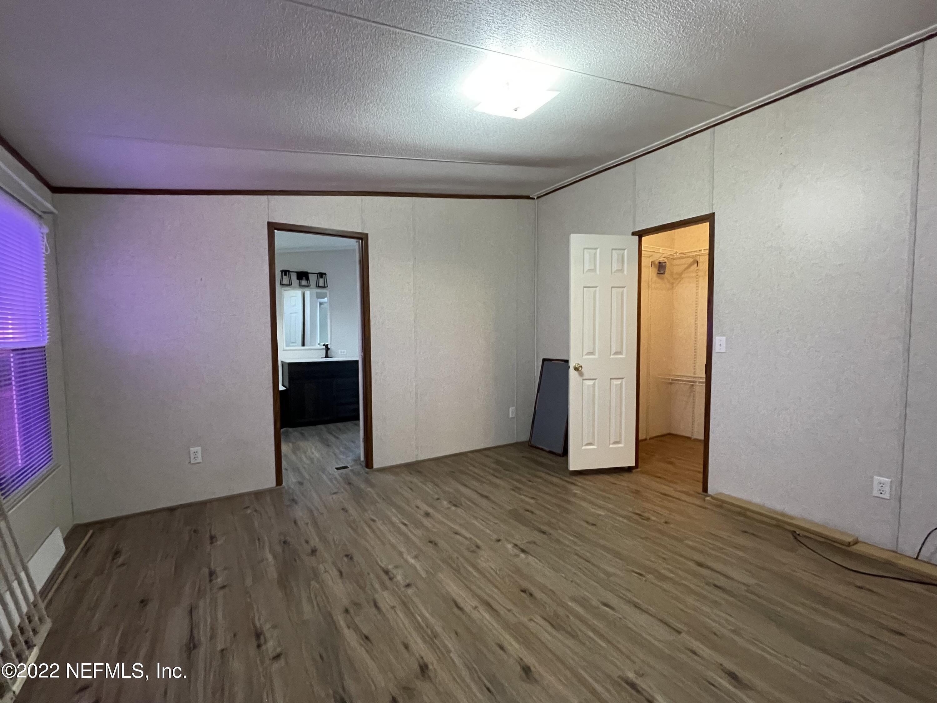 116 Comer Road Palatka, FL 32177 - Photo 47 of 51 an empty room with wooden floor and windows