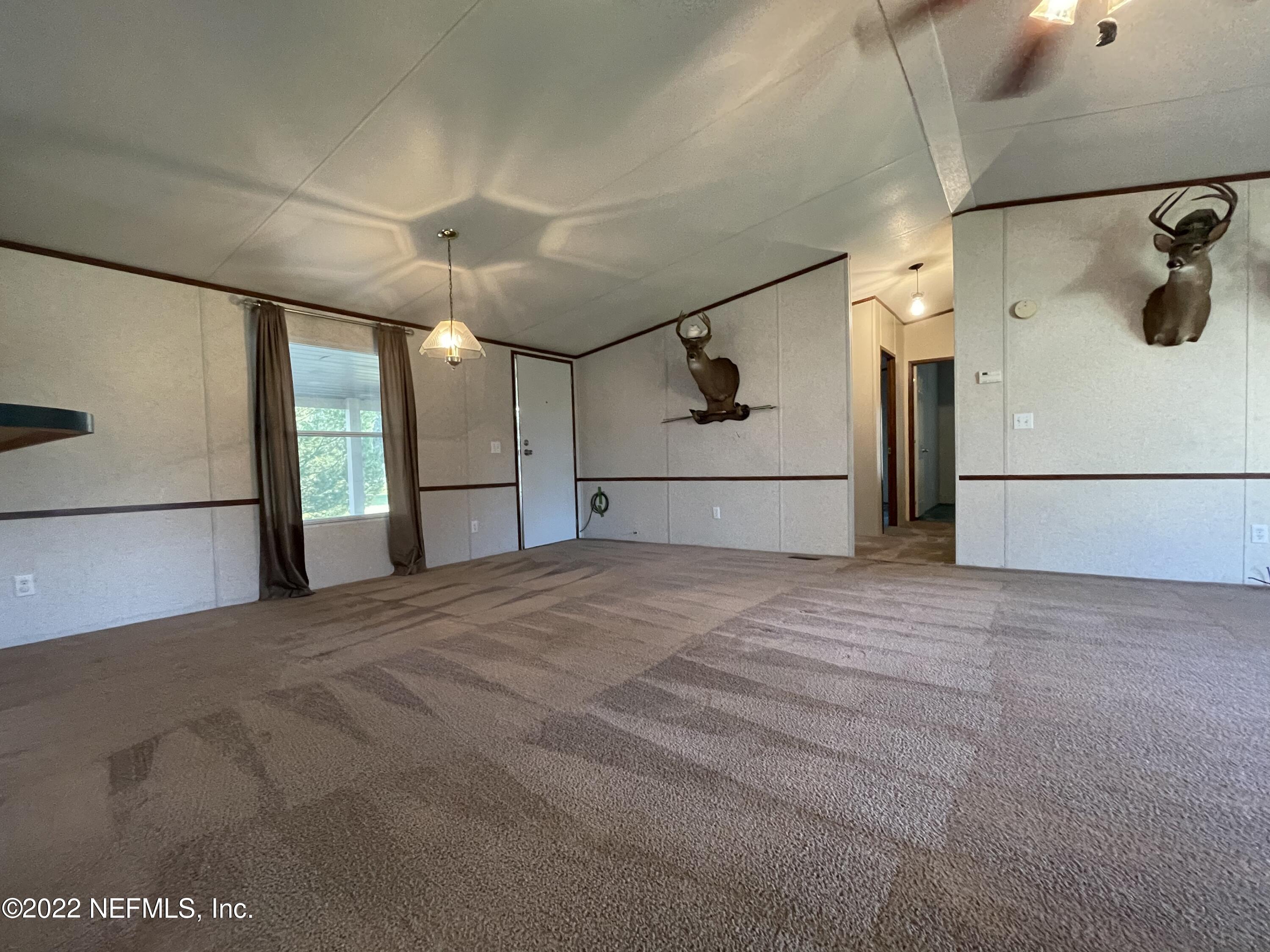 116 Comer Road Palatka, FL 32177 - Photo 49 of 51 a view of empty room with windows and refrigerator