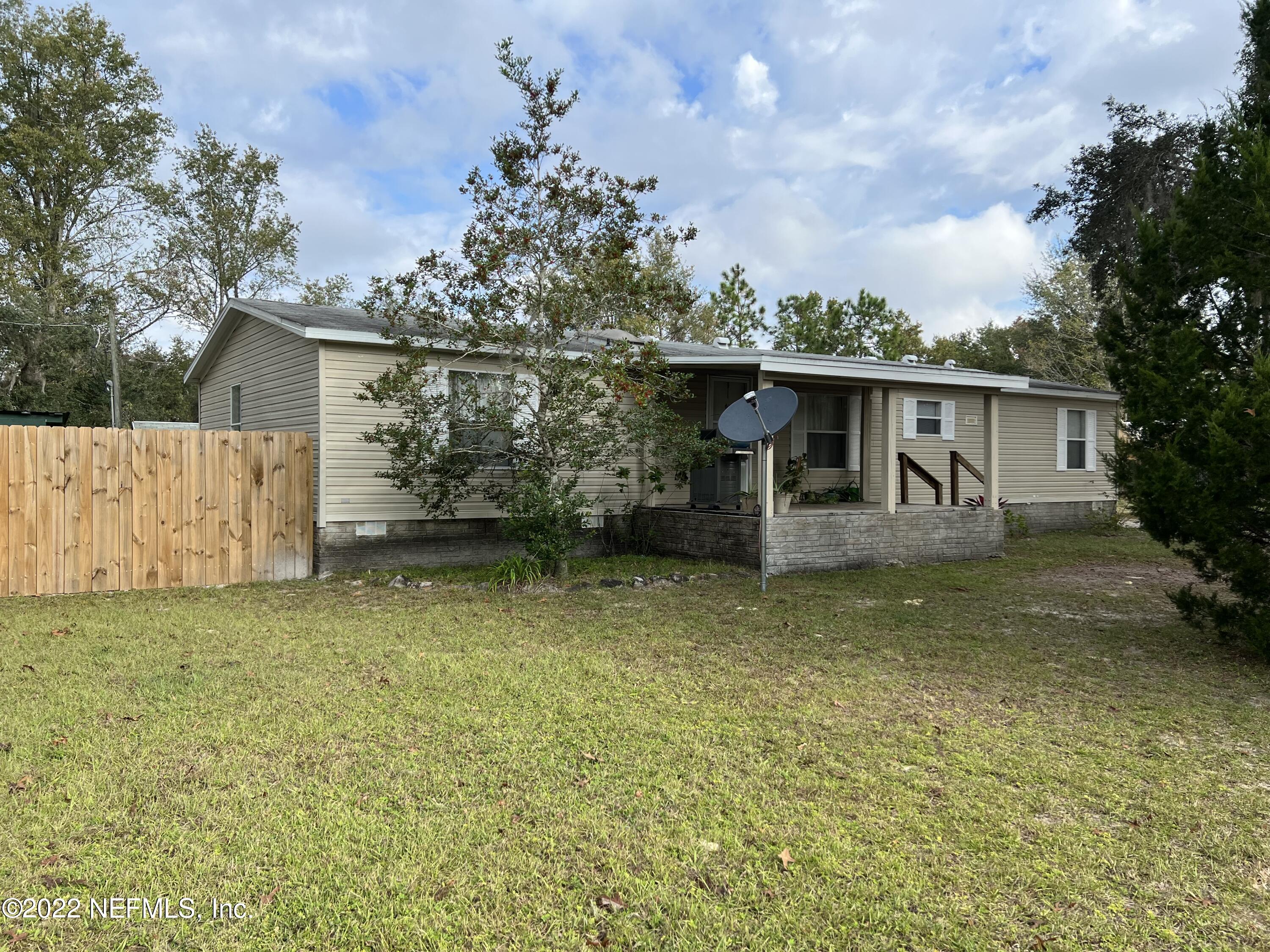 116 Comer Road Palatka, FL 32177 - Photo 5 of 51 a front view of a house with garden