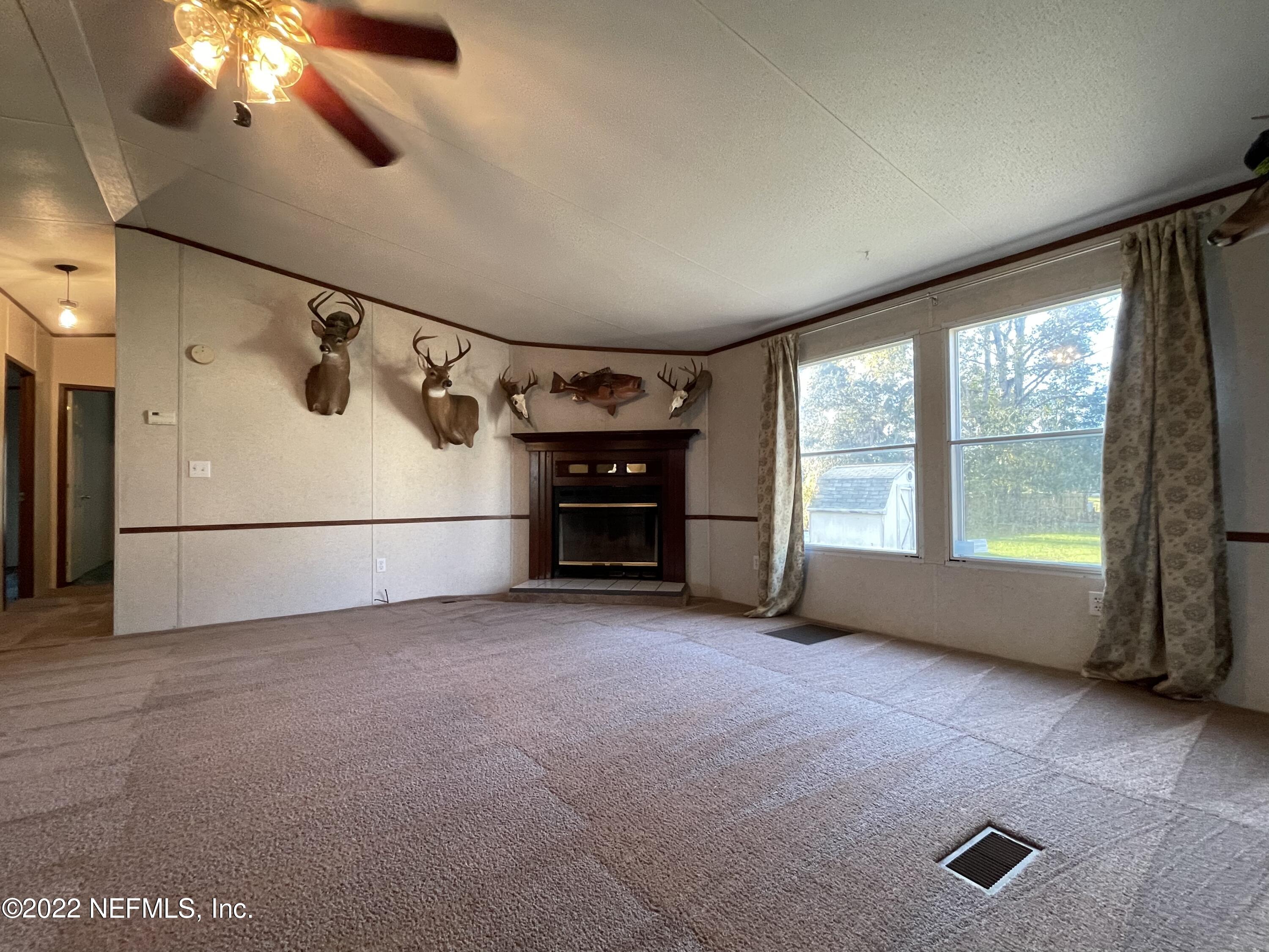 116 Comer Road Palatka, FL 32177 - Photo 51 of 51 a view of an empty room with a fireplace and a window
