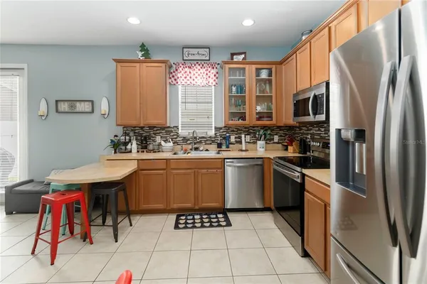 a kitchen with stainless steel appliances a sink counter space and a window