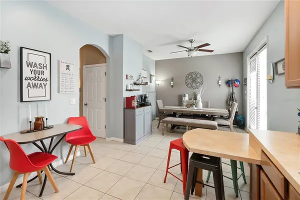 a room with furniture a rug and a chandelier fan