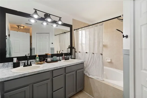 a bathroom with a double vanity sink mirror double and shower