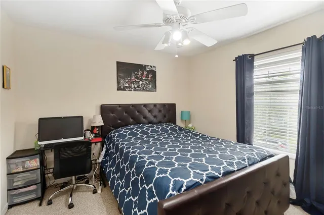 a bedroom with a bed and a desk