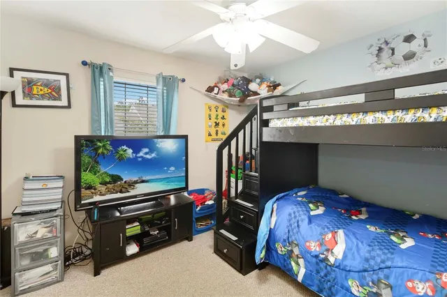 a bedroom with furniture and a flat screen tv