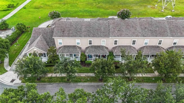 an aerial view of house with yard and outdoor seating