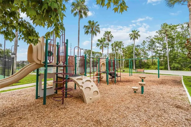 a view of park with swings and slide