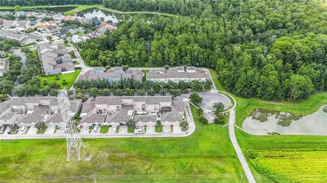 an aerial view of a house with a garden and lake view