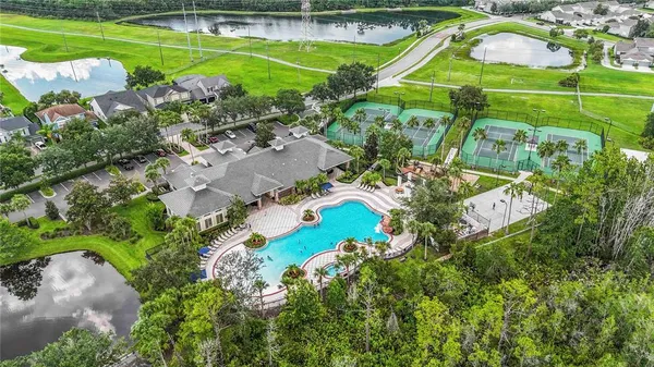 an aerial view of a house with a yard basket ball court and outdoor seating