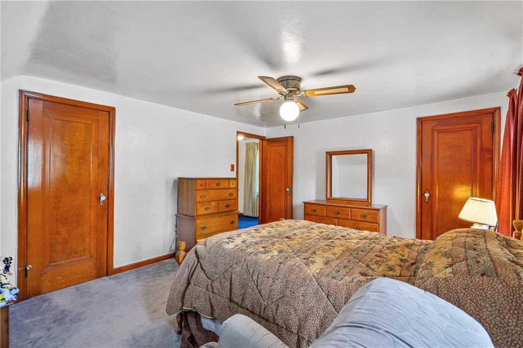 1031 Anderson Road Pittsburgh, PA 15209 - Photo 20 of 35 a bedroom with a bed and a chandelier