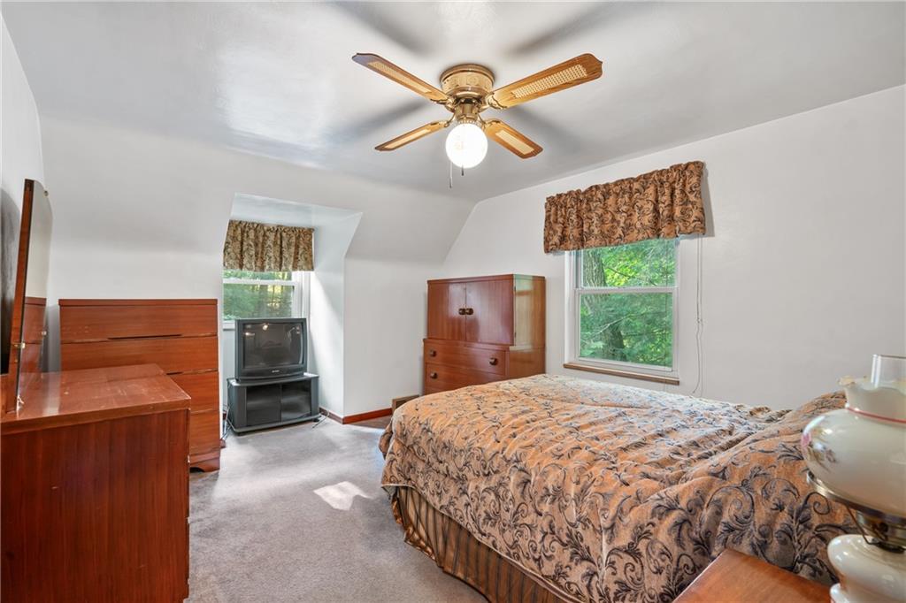 1031 Anderson Road Pittsburgh, PA 15209 - Photo 21 of 35 a bedroom with a bed and a chandelier