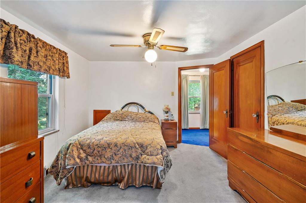 1031 Anderson Road Pittsburgh, PA 15209 - Photo 23 of 35 a bedroom with a bed and a chandelier