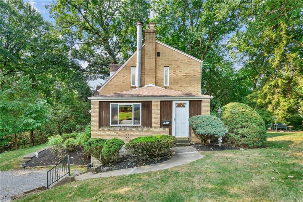 1031 Anderson Road Pittsburgh, PA 15209 - Photo 30 of 35 a front view of a house with a yard and potted plants