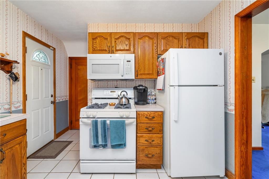 1031 Anderson Road Pittsburgh, PA 15209 - Photo 9 of 35 a white refrigerator freezer sitting inside of a kitchen