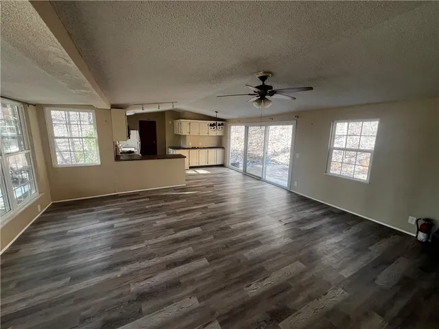 a kitchen with a sink a microwave a refrigerator and cabinets