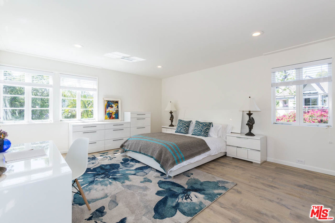 5 Richland Place Pasadena, CA 91103 - Photo 31 of 54 a spacious bedroom with a large bed and a wooden floor