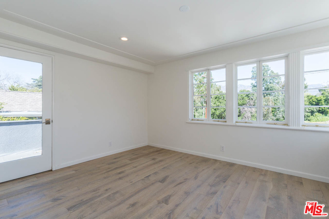 5 Richland Place Pasadena, CA 91103 - Photo 39 of 54 an empty room with wooden floor and windows