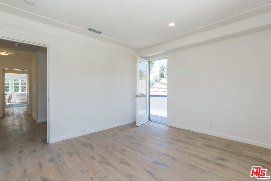 5 Richland Place Pasadena, CA 91103 - Photo 44 of 54 an empty room with wooden floor and windows